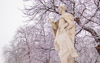 status in a park covered by snow