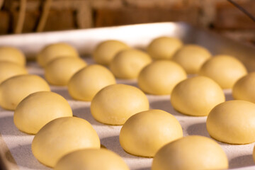 round donut dough expand in baking sheet ready to fried