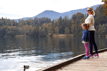 Mother and daughter having a good time on a lake.