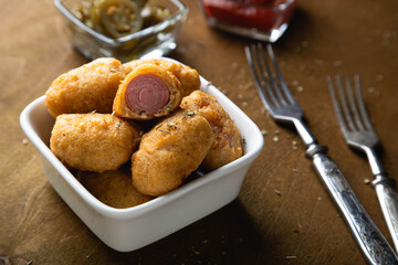 Mini corn dog with ketchup and jalapeno pepper