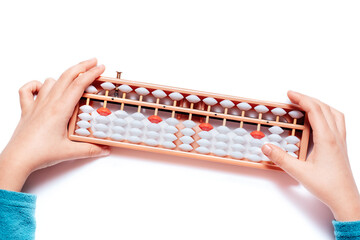 Japanese traditional abacus soroban isolated on white background. Child Hand using abacus. Education and development concept. Back to school, math education, mental mathematics, arithmetic