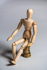 Business concept photo. Wooden man with money. Earnings and salary