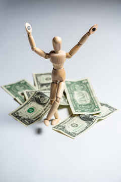 Business concept photo. Wooden man with money. Earnings and salary