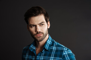 Thinking handsome unshaven guy posing and looking aside
