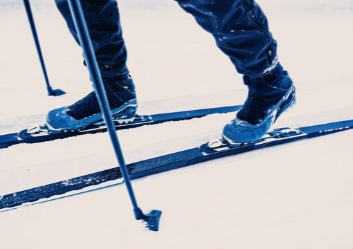 Cross-country skiing. Close up of boots an skis in motion with speed blur.