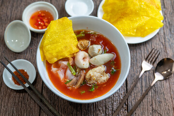 Asian Pink Noodle Soup or Yen Ta Fo noodle with fish ball, crispy wonton in special homemade red sauce.