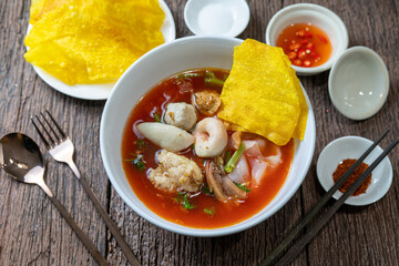 Asian Pink Noodle Soup or Yen Ta Fo noodle with fish ball, crispy wonton in special homemade red sauce.