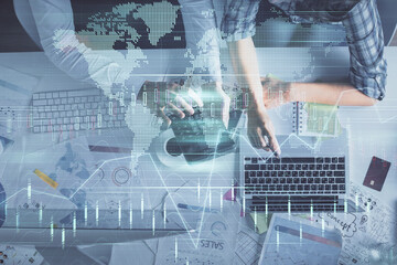 Double exposure of man and woman working together and financial graph hologram drawing. market analysis concept. Computer background. Top View.