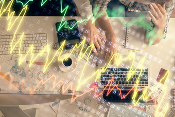 Fototapeta na wymiar Double exposure of man and woman working together and financial graph hologram drawing. market analysis concept. Computer background. Top View.