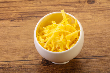 Shredded yellow cheese in the bowl