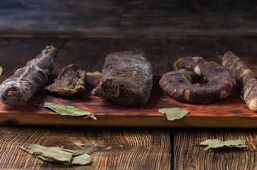 Sausage in a butcher's shop. Assortment of sausages on a wooden board.