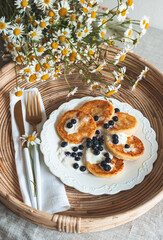 Cottage cheese pancakes with berries, healthy breakfast, yellows flowers, spring, woman's day