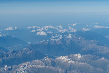 Beautiful View from airplane on the aircraft of the planet Earth cloudy landscape in sunny. Air travel and transportation concept.