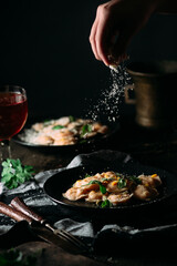 Ravioli with pumpkin and parmesan on a black plate