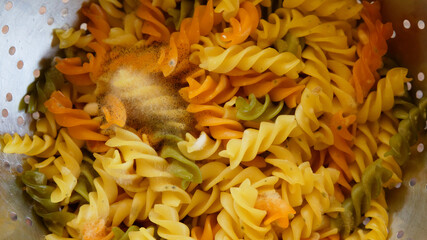 unhealthy mould spores on left over fusilli pasta, cooked corkscrew-noodle decay