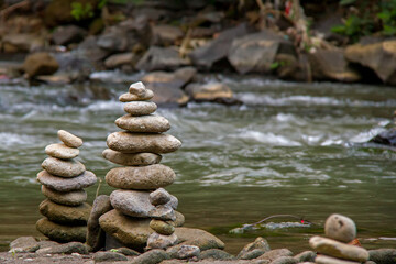 Fototapeta na wymiar Zen Stacked Stones at the Majestic Tegenungan Waterfalls in Bali, Indonesia