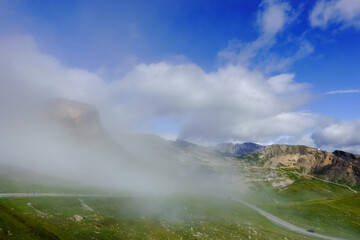 dense fog while driving on a curvy road high in the mountains