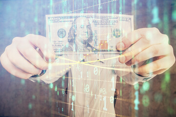 Double exposure of technology drawing hologram and us dollars bills and man hands. Data concept