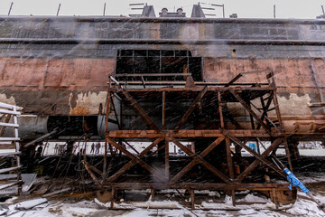 Welding in rain, snow, sawing ship.