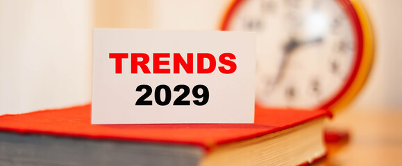 Trends of 2029 on orange background with white business card
