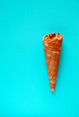 Waffle cone. Ice cream cone close-up on a blue surface.