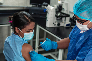 Fototapeta na wymiar Doctor administering vaccine during pandemic