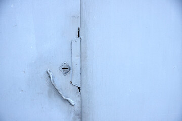background of metal garage doors with keyhole and metal handle