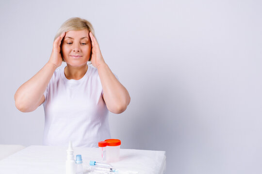Senior caucasian woman with flu and cold symptoms holding her head from the number of tests and medications on a white background with empty side space. - Powered by Adobe