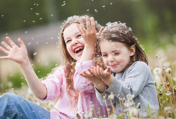 Beatiful children collecting flowers and playing with dandelions