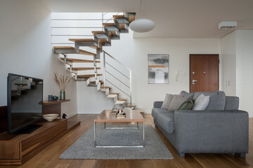 Simple living room with modern stairs