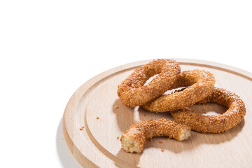 Traditional middle eastern sesame ring cookies called kandil simidi on wooden plate
