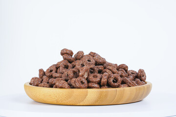 Chocolate quick breakfast cereal on white background, close view.