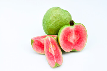 One whole guava fruit, a half and a slice with pink flesh isolated on white background