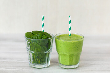 Healthy green smoothie with spinach and avocado on wooden table 