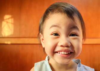 Charming 3 years old Asian Thai little girl smilling at home.