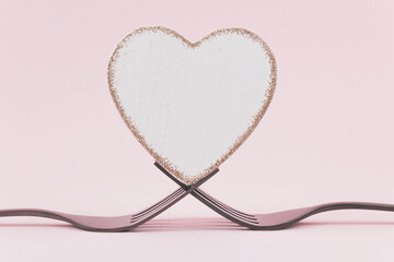 White heart between two forks on a pink background.