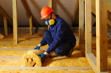 Man installing thermal roof insulation