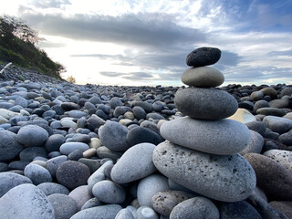 Fototapeta na wymiar Zen-like stack of pebbles, meditation mood on shore