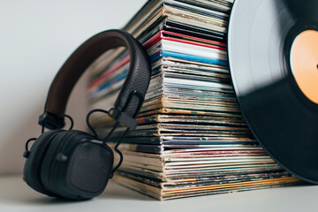 Close up of headphones and stack of vinyl records