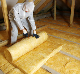 Worker insulate the attic with mineral wool