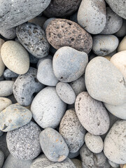 Fototapeta na wymiar Different colors of pebbles on Reunion island east sea shore