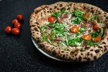 Fresh Rucola Pizza with parma ham and prosciutto
