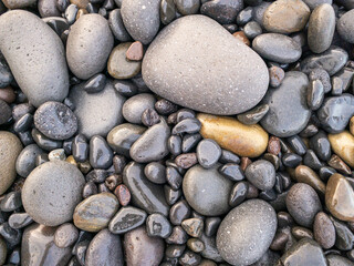 Different colors of pebbles on Reunion island east sea shore