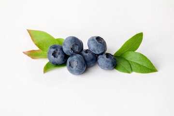 Blueberries with leaves on white background