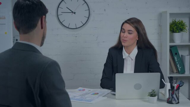 businesswoman talking during job interview with candidate in office
