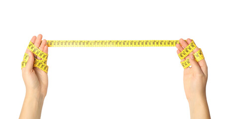 Woman holding yellow measuring tape on white background, closeup