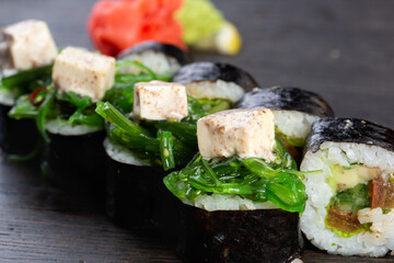 traditional vegetarian Japanese sushi with avocado and soft cheese, cucumber and algae. Japanese kitchen. Japanese restaurant.
