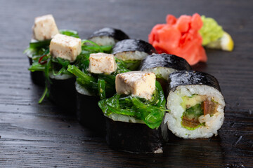 traditional vegetarian Japanese sushi with avocado and soft cheese, cucumber and algae. Japanese kitchen. Japanese restaurant.
