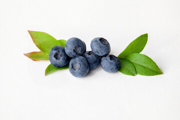Blueberries with leaves on white background
