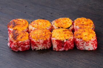 .traditional baked Japanese sushi with salmon, avocado and soft cheese and red caviar, decorated with sauce. Japanese kitchen. Japanese restaurant. warm sushi